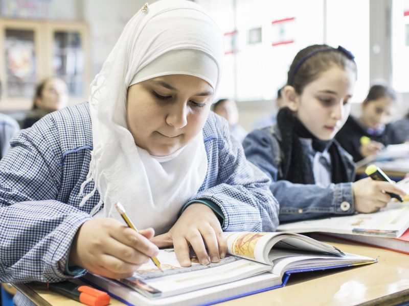 Girls working at desks in a classroom