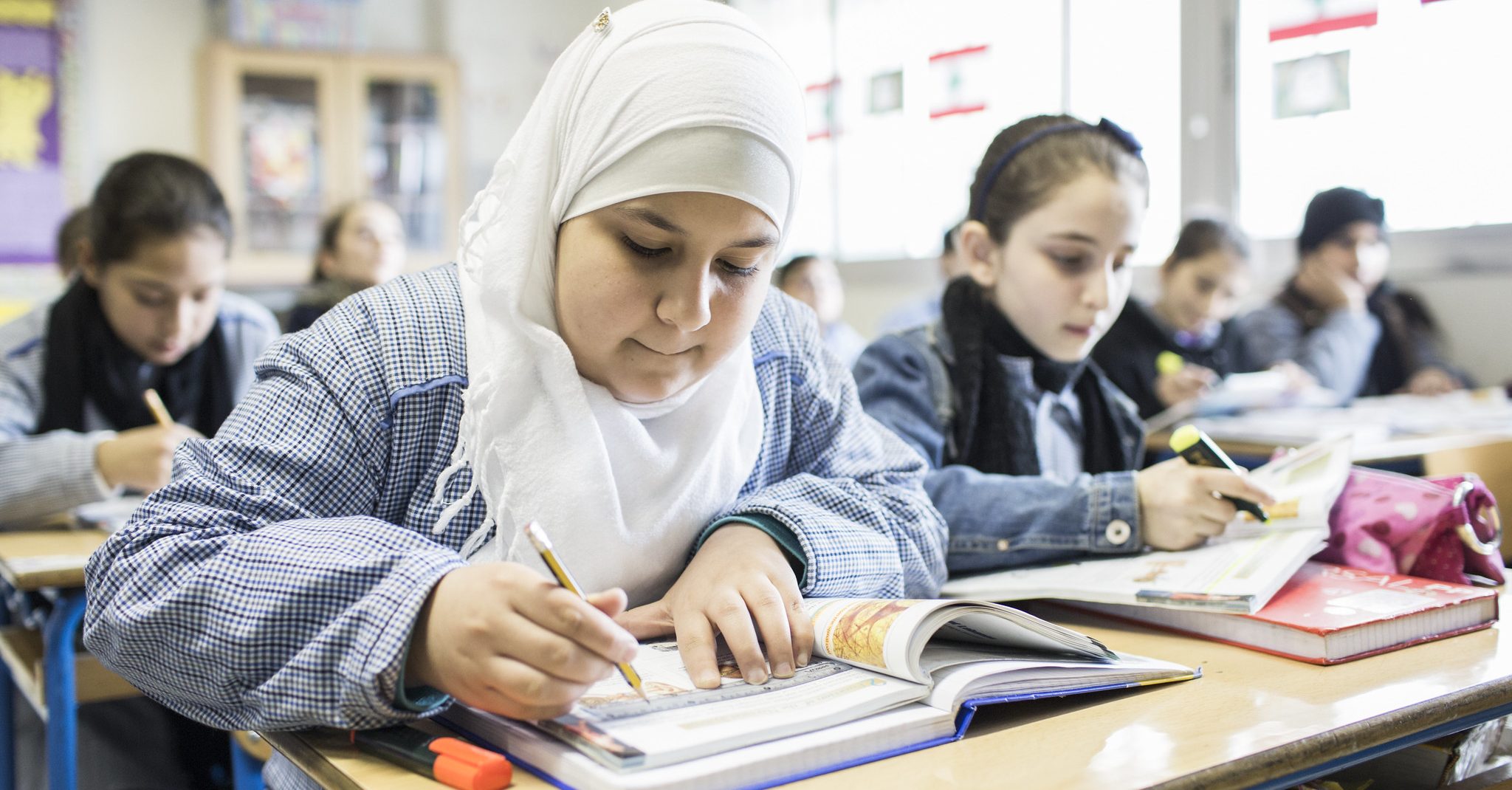 Girls working at desks in a classroom