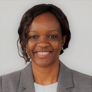 Head shot of a smiling African lady wearing a grey jacket