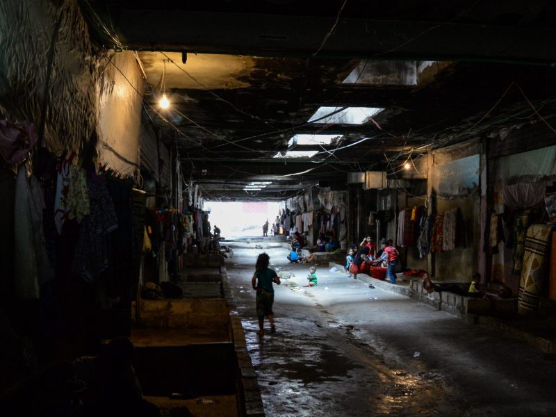 A dark underpass with people in the middle distance