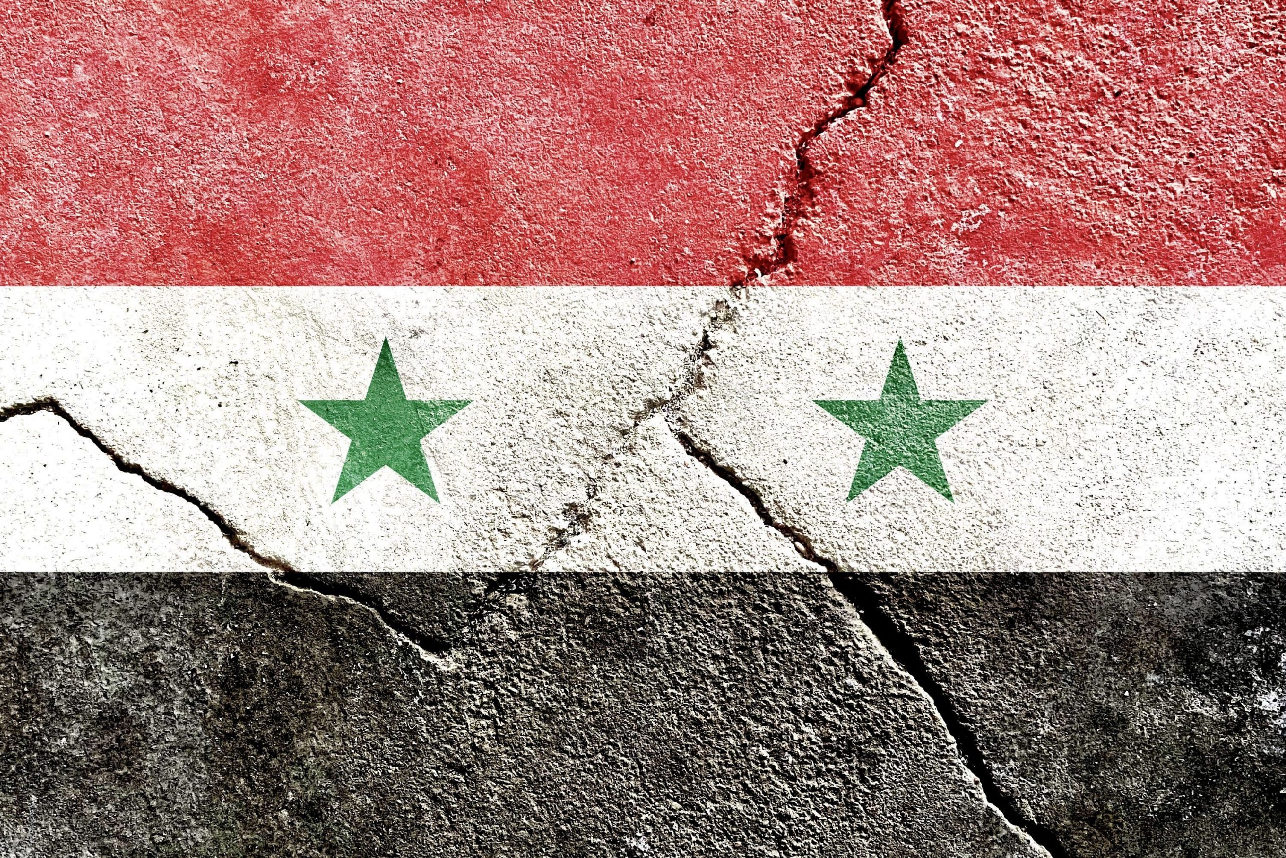 Syrian flag on a cracked background