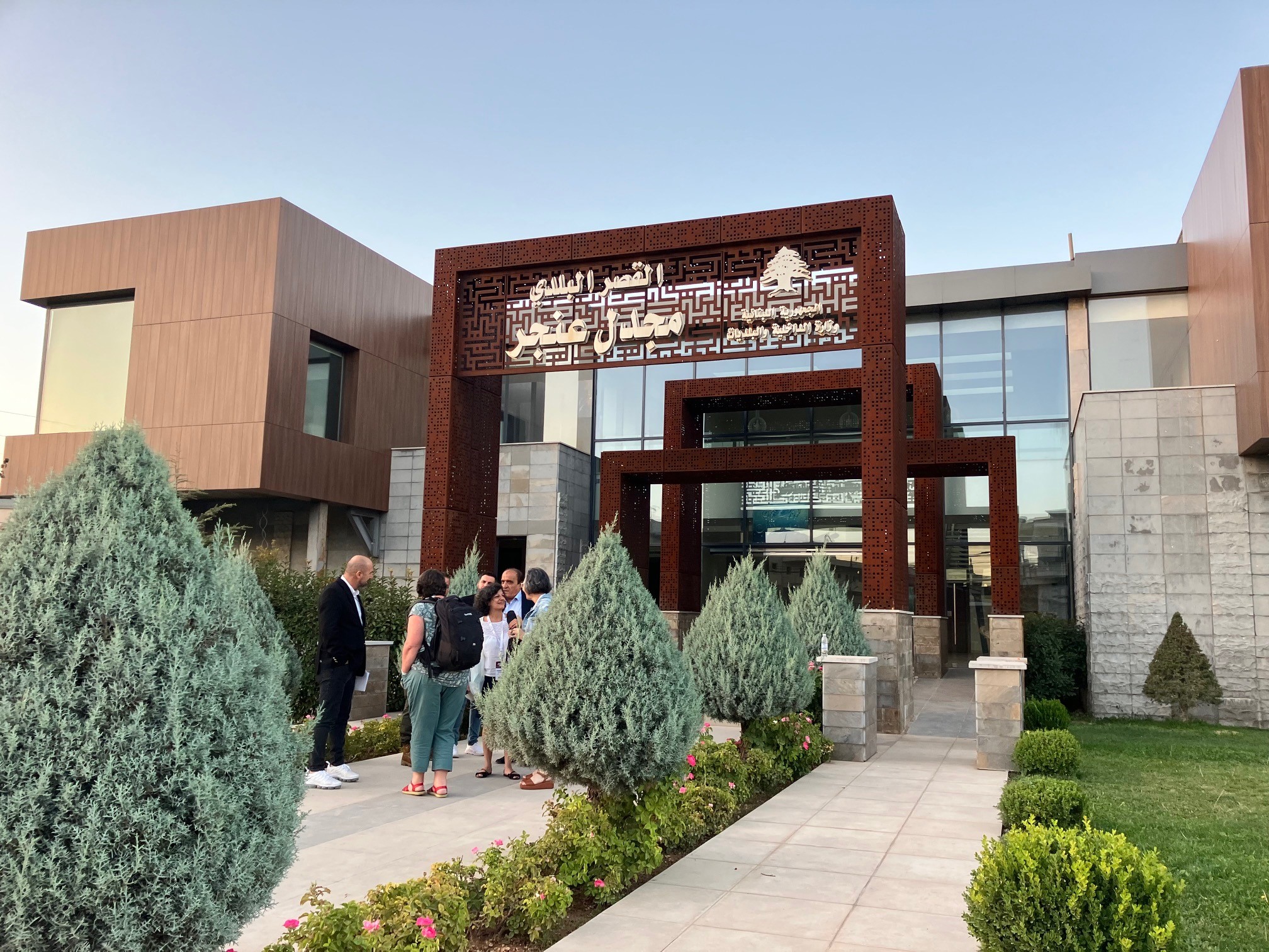 A modern building with Arabic lettering above the door