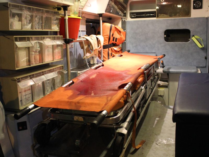 A blood-stained stretcher in the back of an ambulance