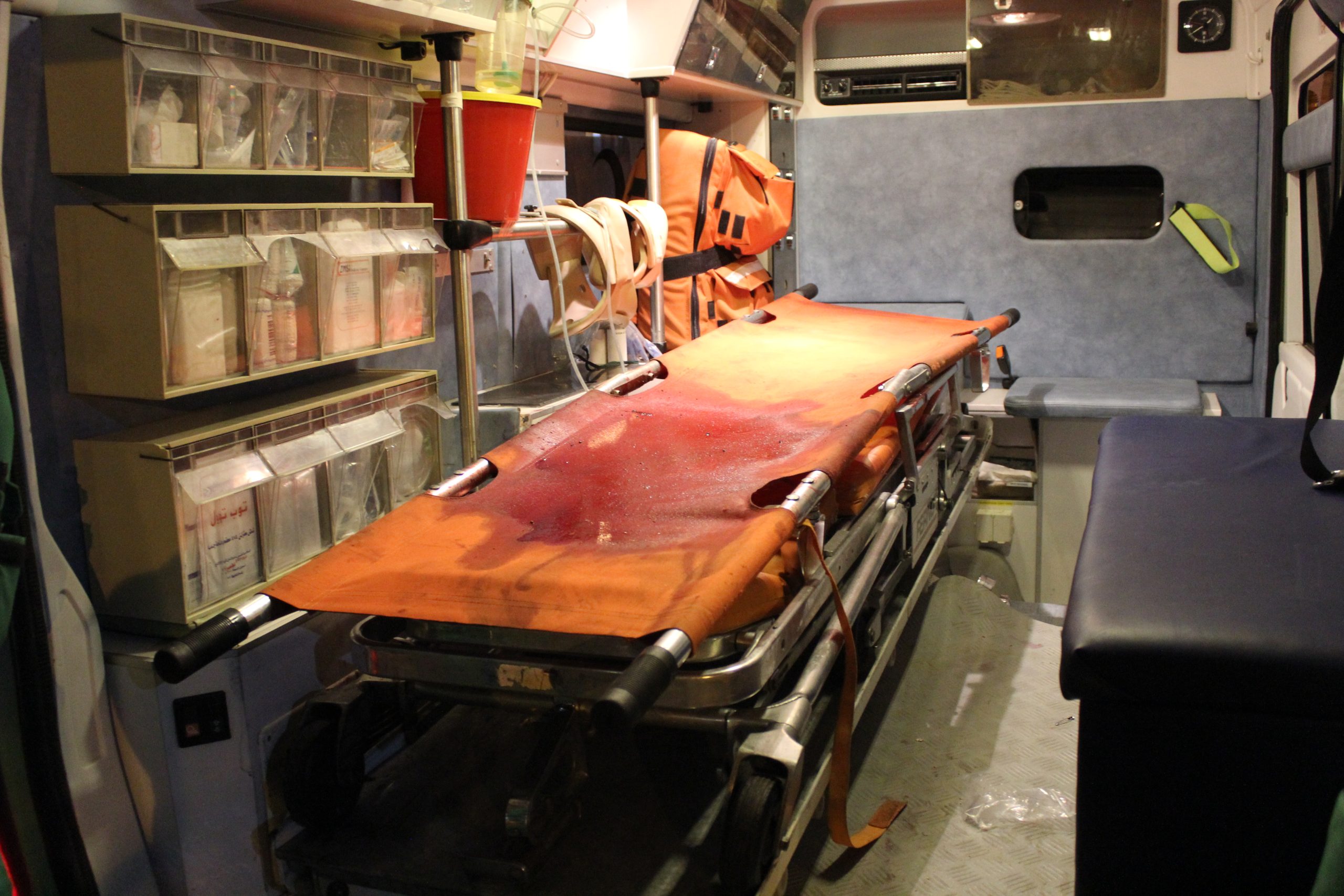 A blood-stained stretcher in the back of an ambulance